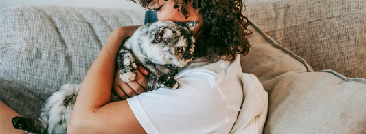 a woman hugs her cat